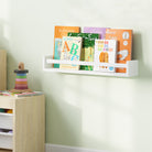 A white nursery shelf for kids room with a natural wood rod in a child's room, filled with children's books. Mounted on a light green wall beside a toy organizer, creating a neat and accessible reading space.