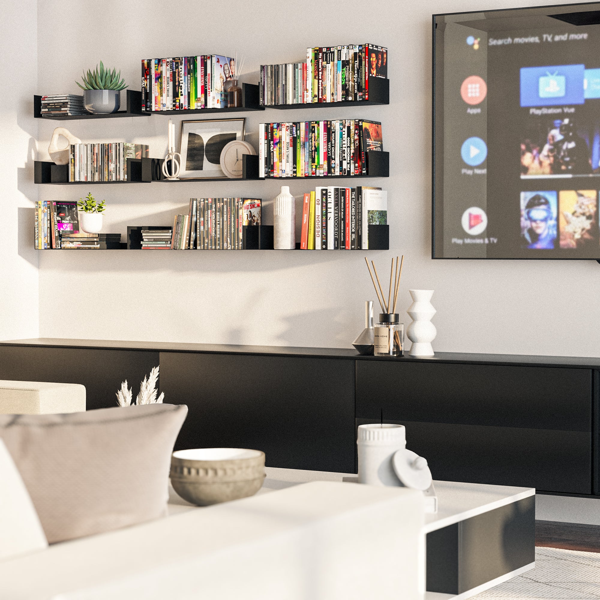 Modern media room with black floating shelves holding books and decor items, adding a stylish, organized touch to a space designed for entertainment and relaxation.