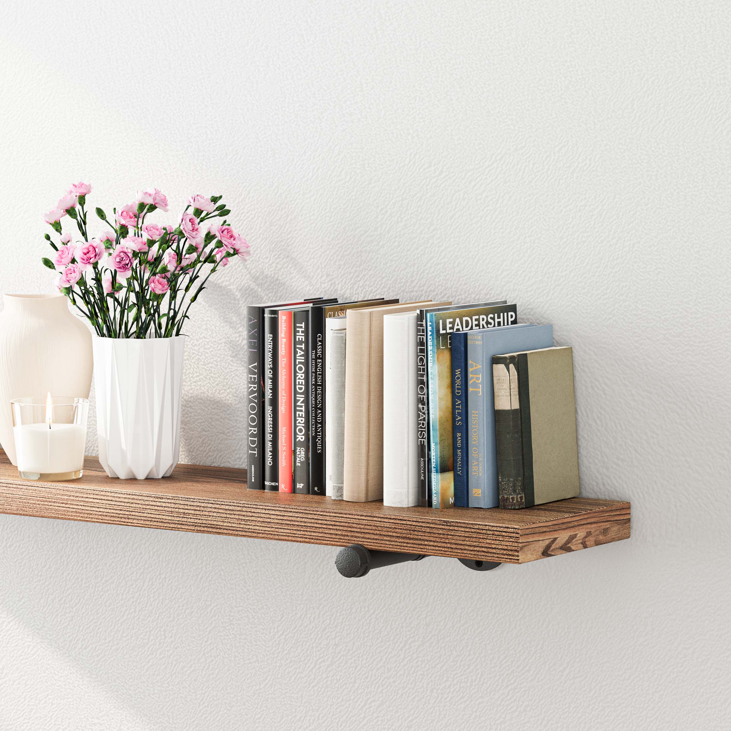 The shelf is decorated with books, a vase with pink flowers, a candle, and a small ceramic item. This setup showcases the shelf's capacity and its ability to enhance room decor.