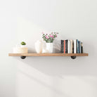 A full view of the shelf displaying a mix of books, plants, and decor items, demonstrating its spaciousness and versatility for various home decor styles.