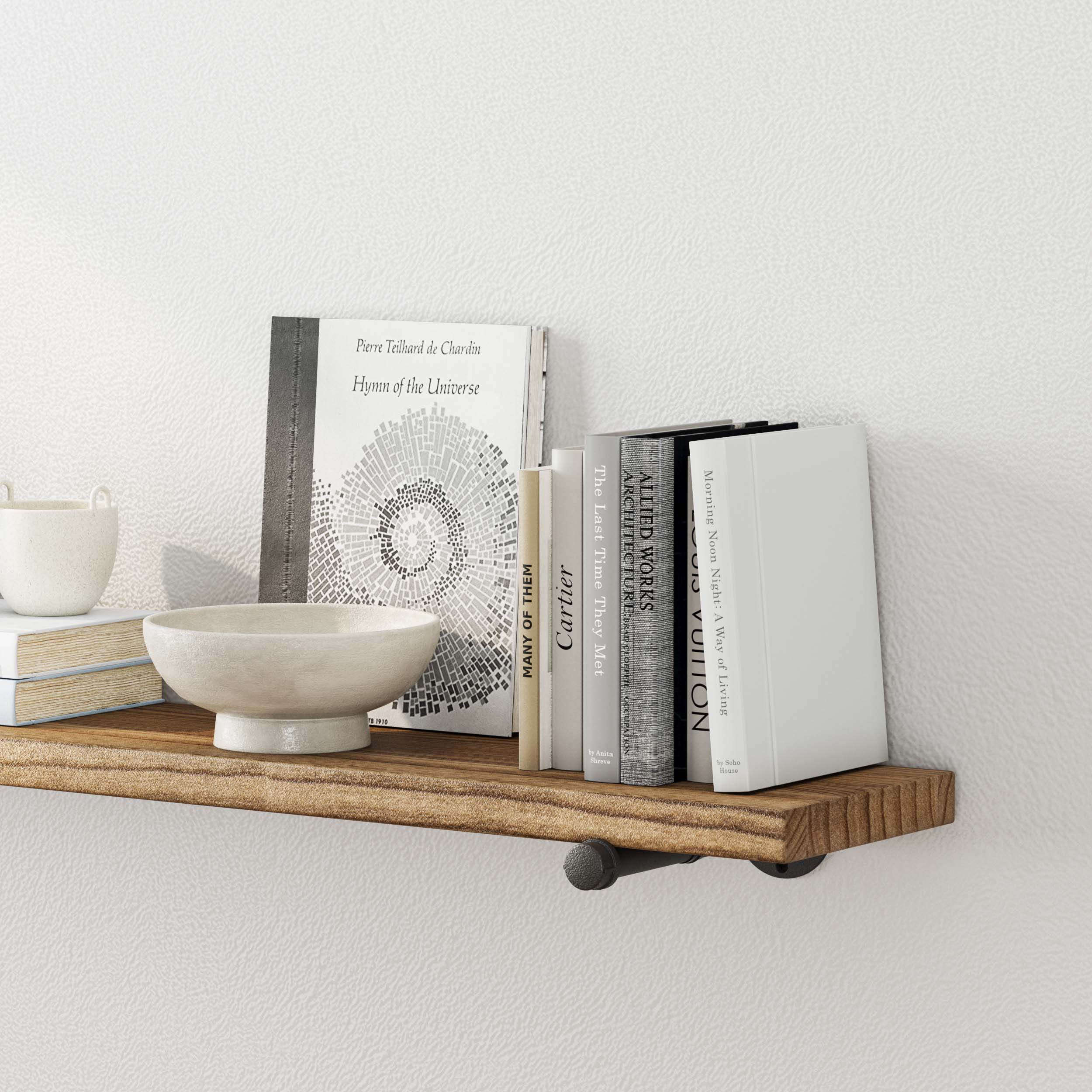 A close-up of the shelf displaying books and a decorative bowl, highlighting its ample space for organizing small items.