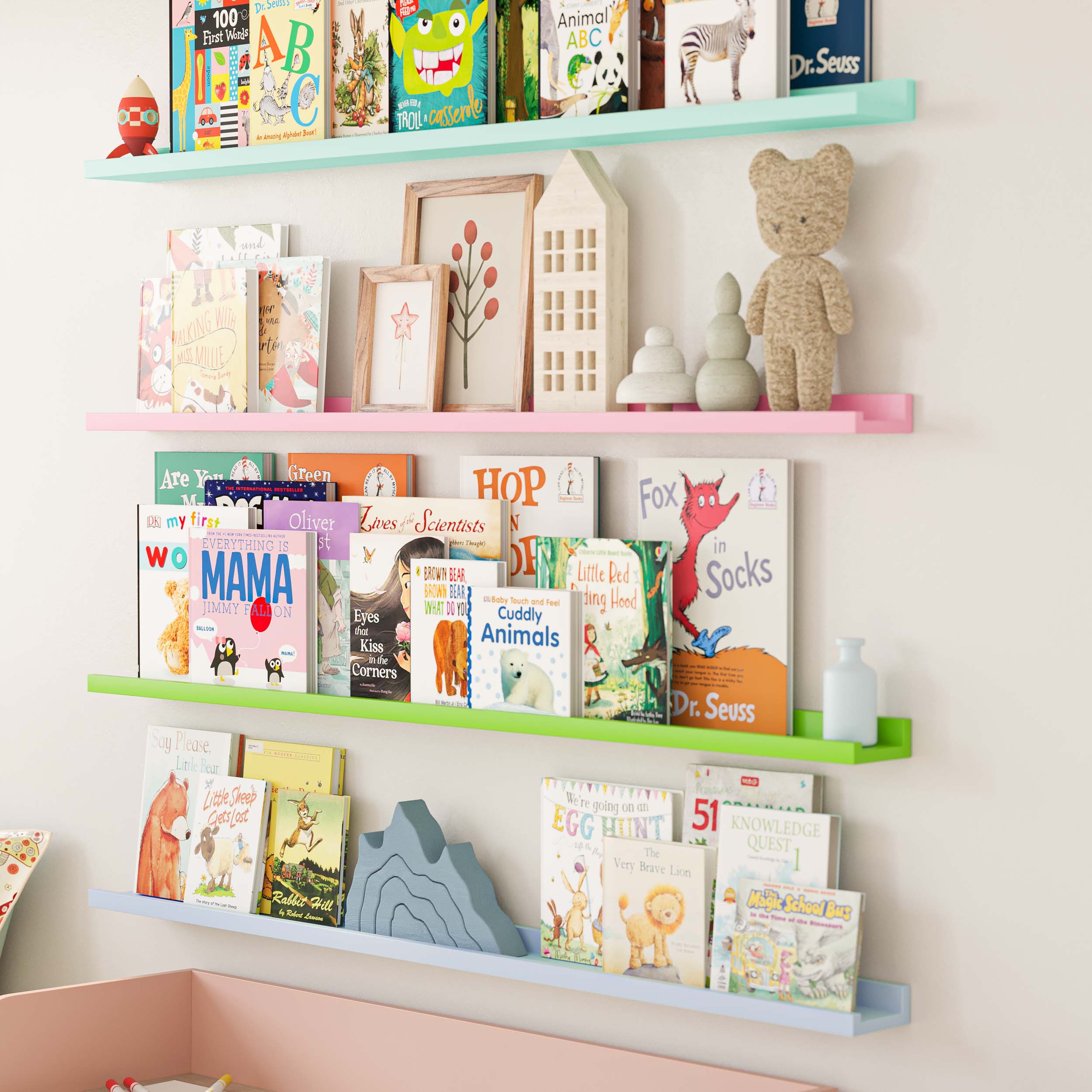 a closer view of the pastel-colored shelves from the first image, focusing on the books and decorative items like a teddy bear and framed pictures. The setup is bright and organized, ideal for a child's room.