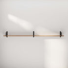 Empty wood floating shelf on a white wall, showcasing minimalistic design.
