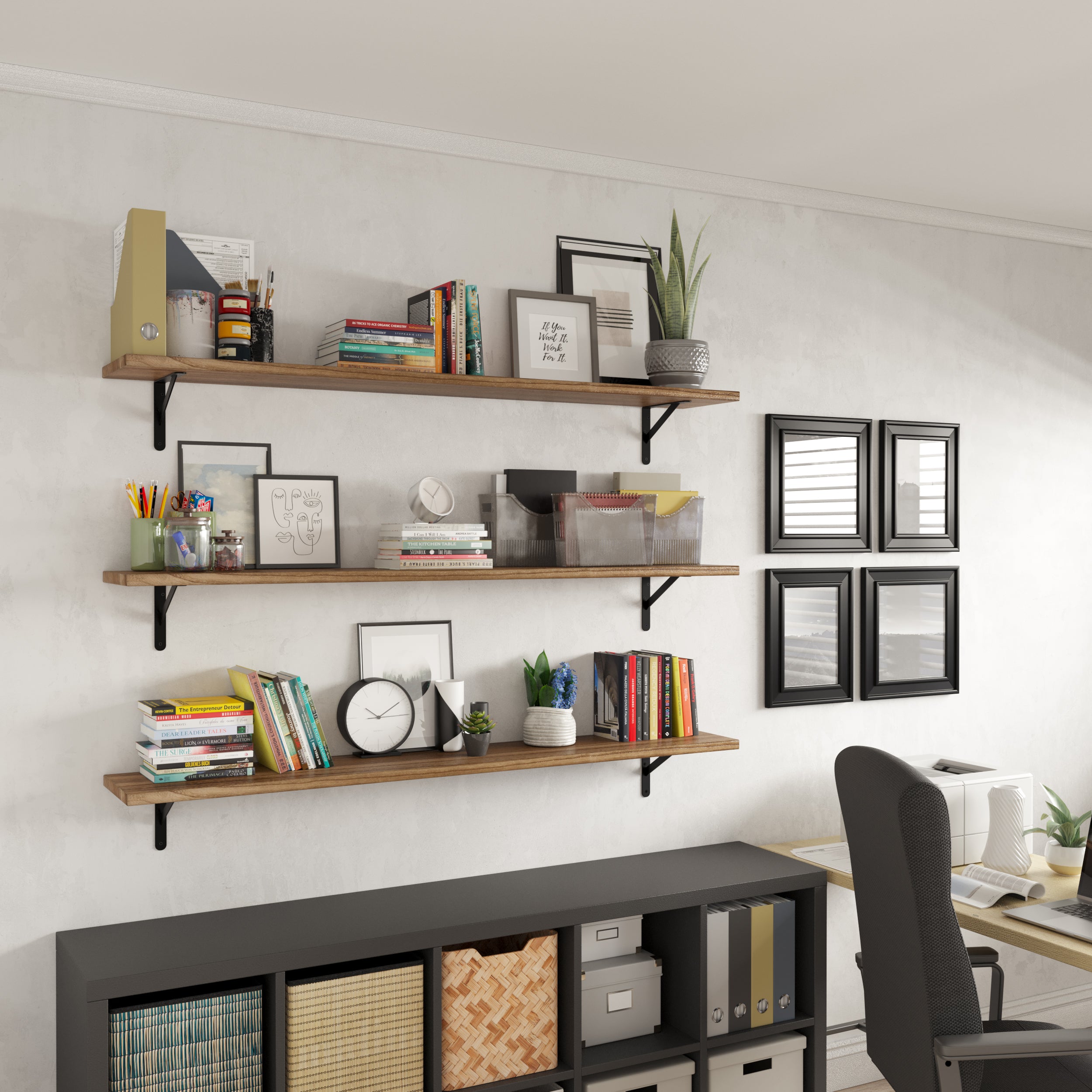 Long rustic shelves adorned with colorful book, framed prints and artificial plants for a cozy home office wall decor.