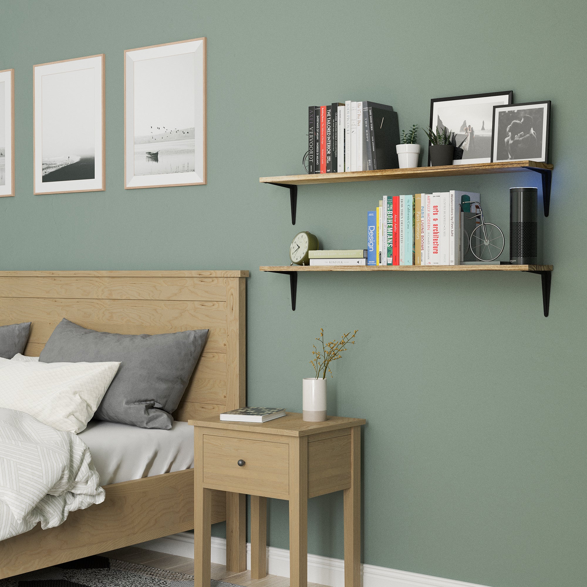 Two rustic bedroom shelves in a bedroom filled with books, pictures, and decor items against a green wall.