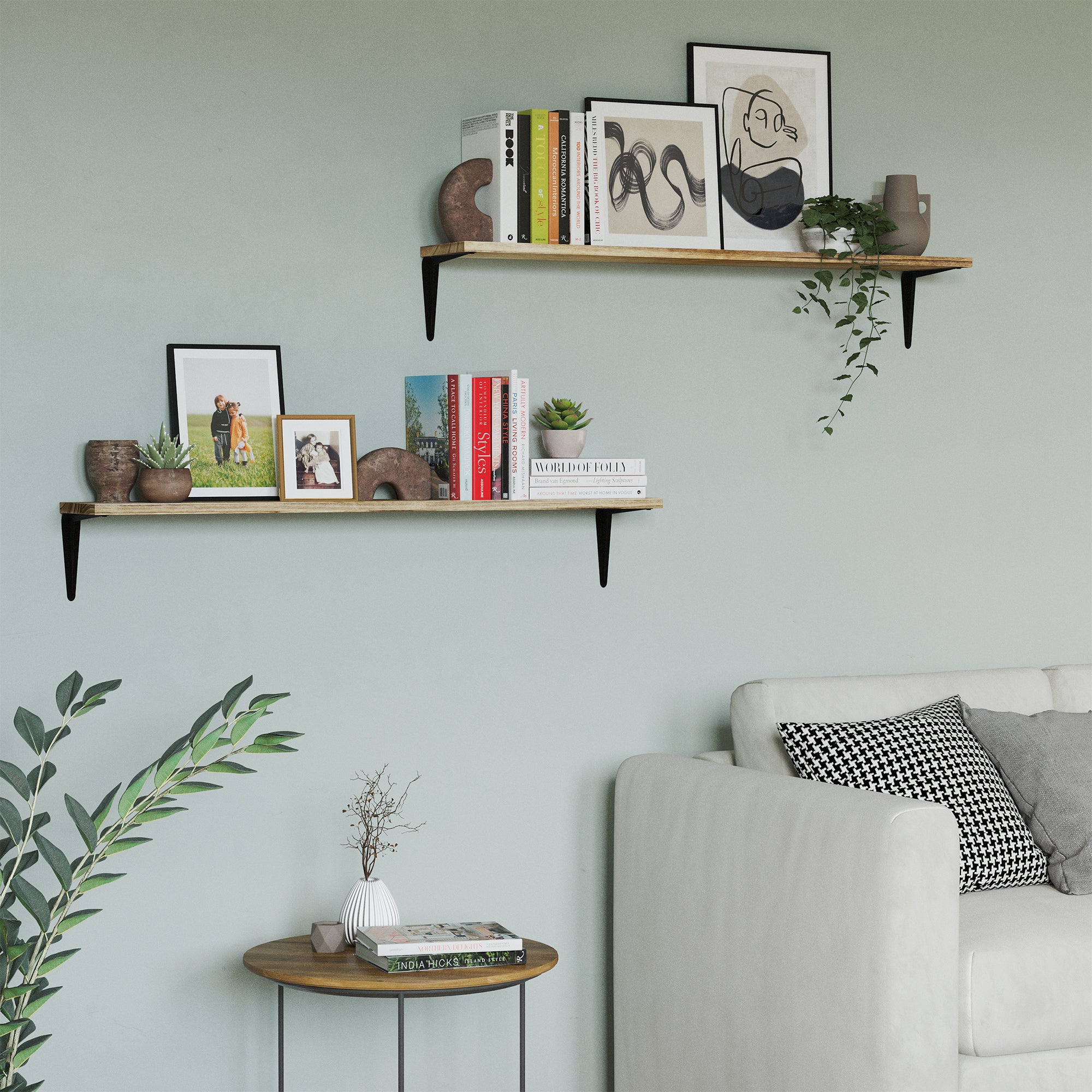 Two hanging shelves for wall with black brackets used for books and decor. One shelf is above the other, adding dimension and warmth to a soft green wall.