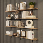 Four floating book shelves with neutral books, vases, and textured décor. Warm lighting and earthy tones make it a standout design feature.