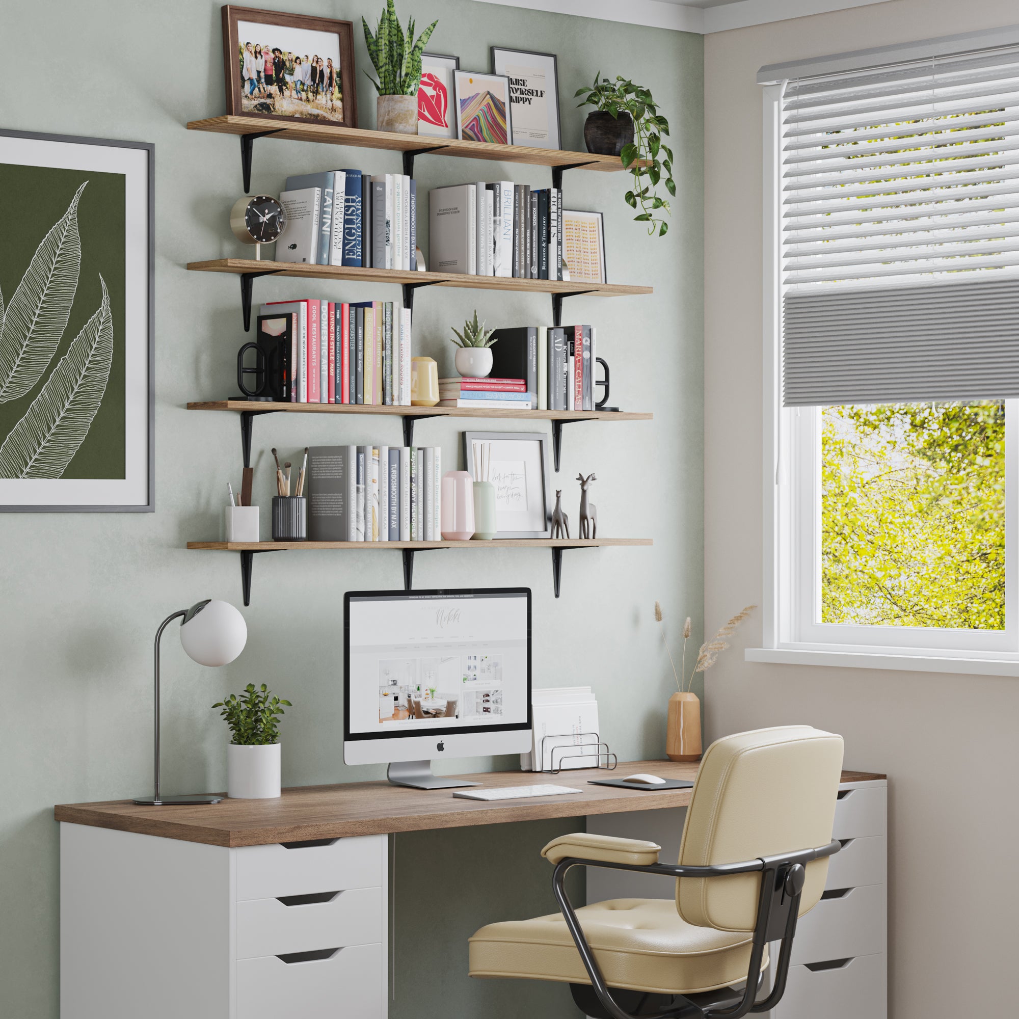 A home office wall with four floating office shelves above a desk. Books, plants, and framed prints offer both function and style for a productive workspace.