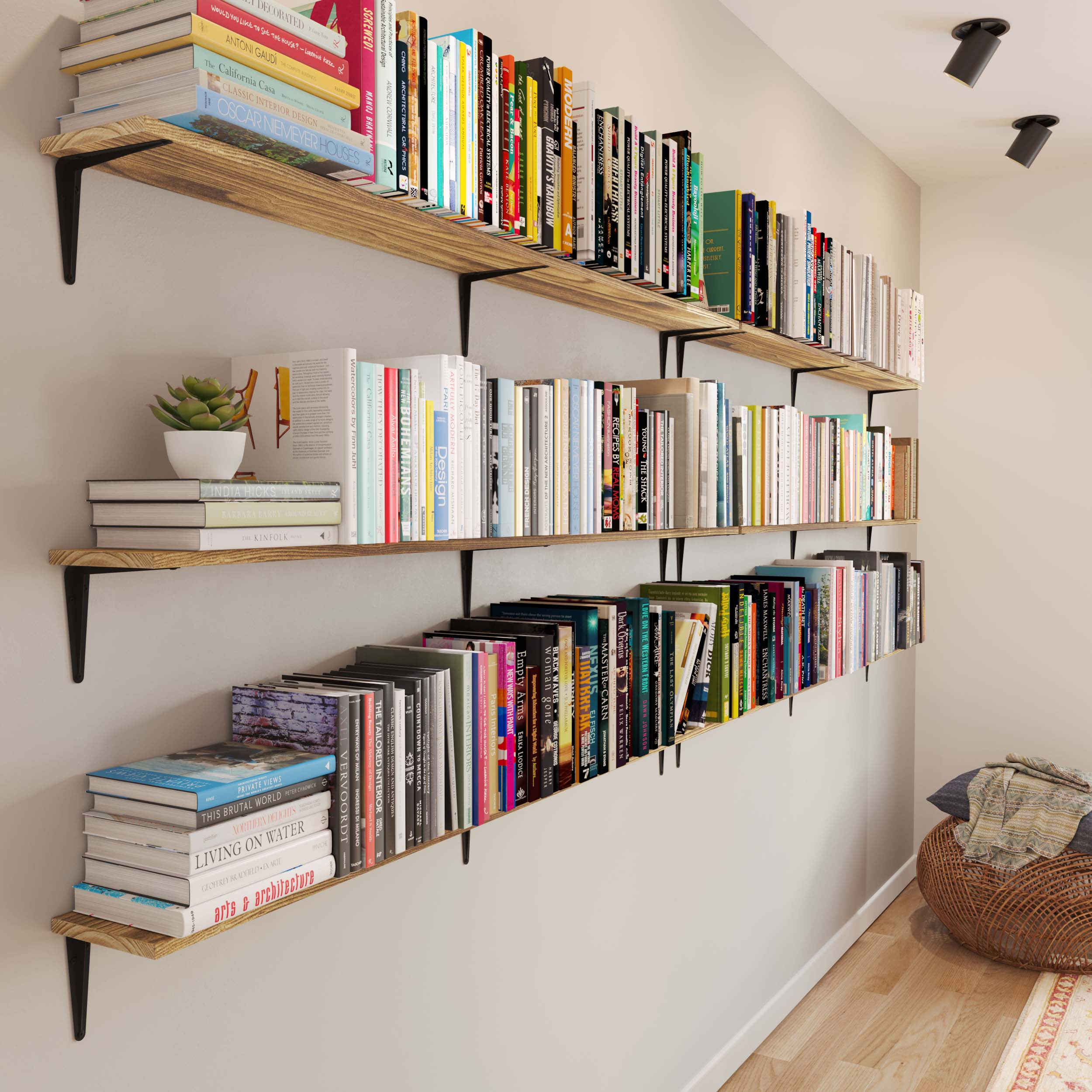 A long wall lined with rustic tall shelves filled with a colorful array of books, adding a lively touch to a minimalist room.