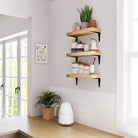 Kitchen with floating kitchen storage shelves supported by black metal brackets, ideal for kitchen storage and decor.