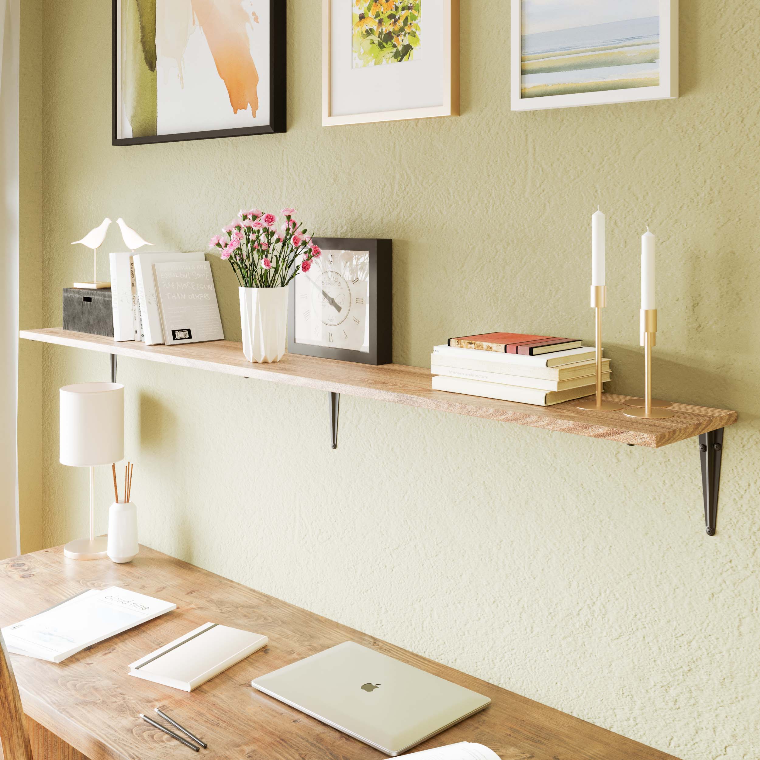 A boho wood shelf mounted above a rustic desk in a home office setup, adorned with books, flowers, framed art, and candles—ideal for blending work and warmth.