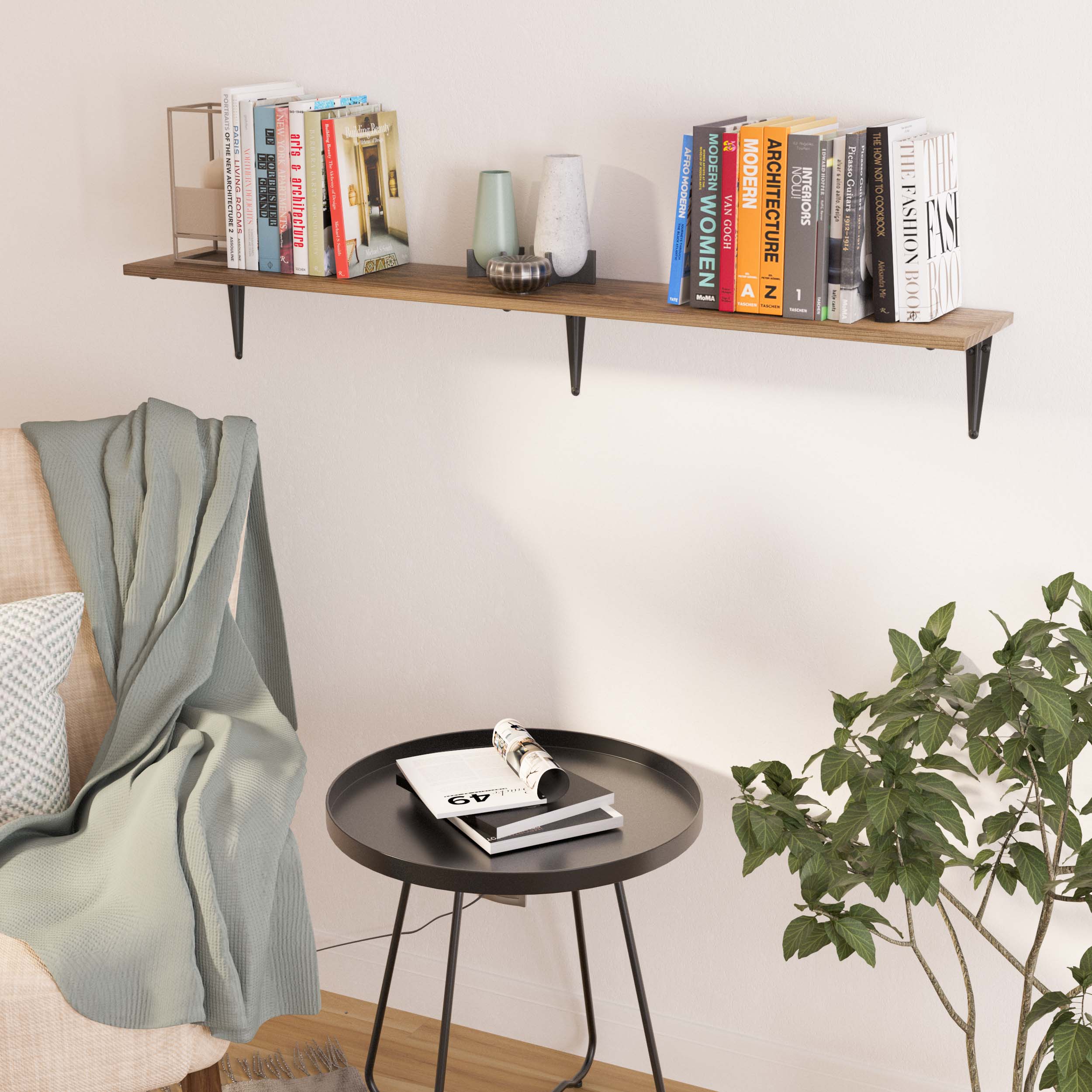 Simple hanging shelf for living room holding books and decorative pieces over a black round side table and a cozy armchair, ideal for compact reading corners.