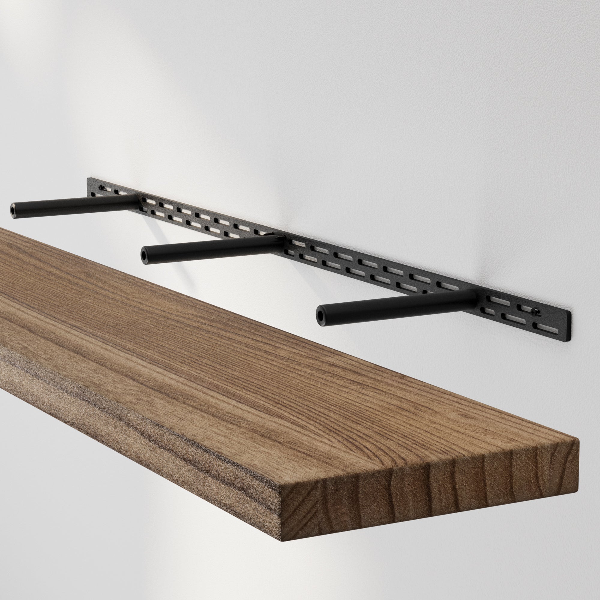 A floating shelf installation with a hidden bracket system. Steel rods support a thick solid wood board for a seamless, bracket-free appearance.