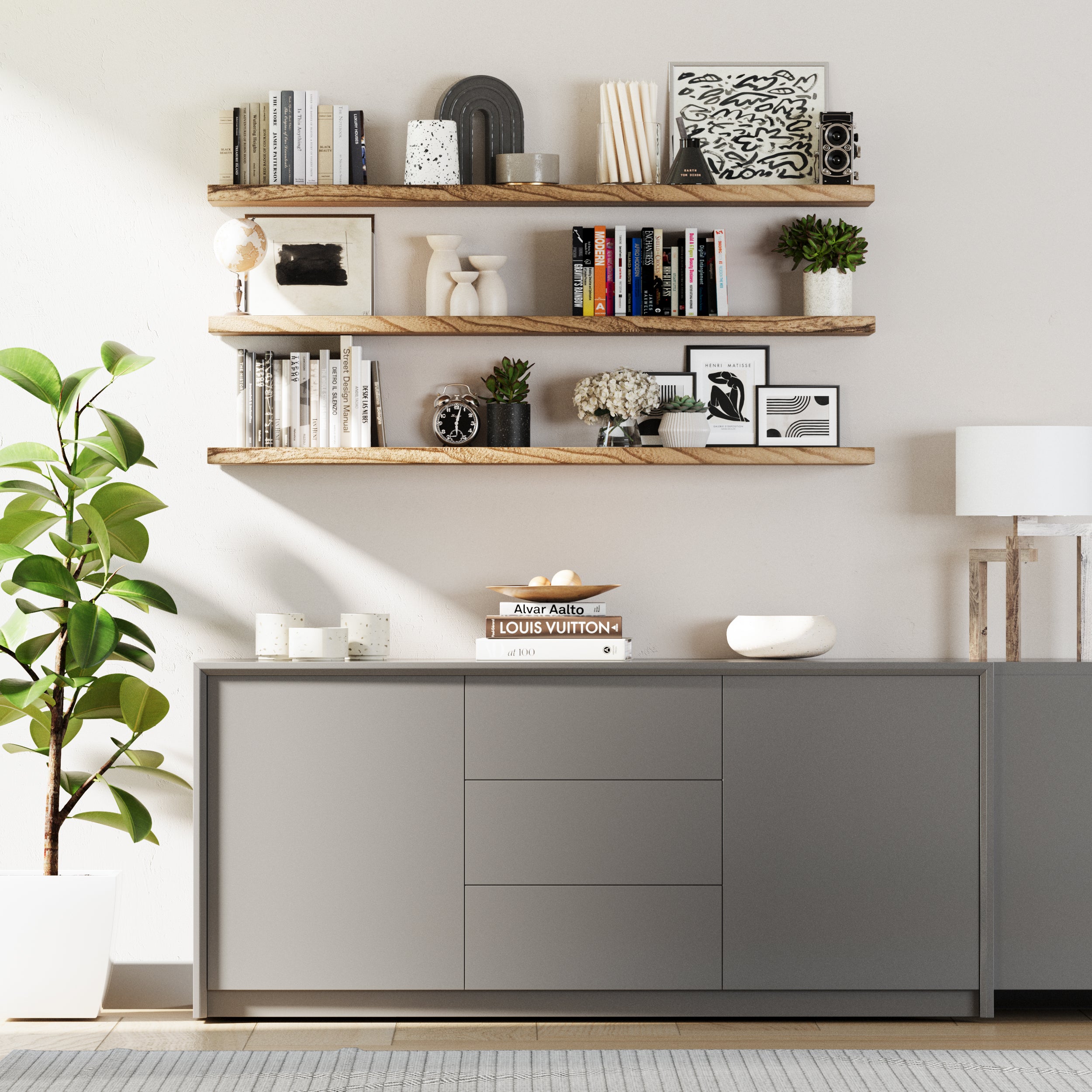 3 floating wall shelves with invisible brackets mounted on a living room wall displaying vintage props, books, flower vase, and clock