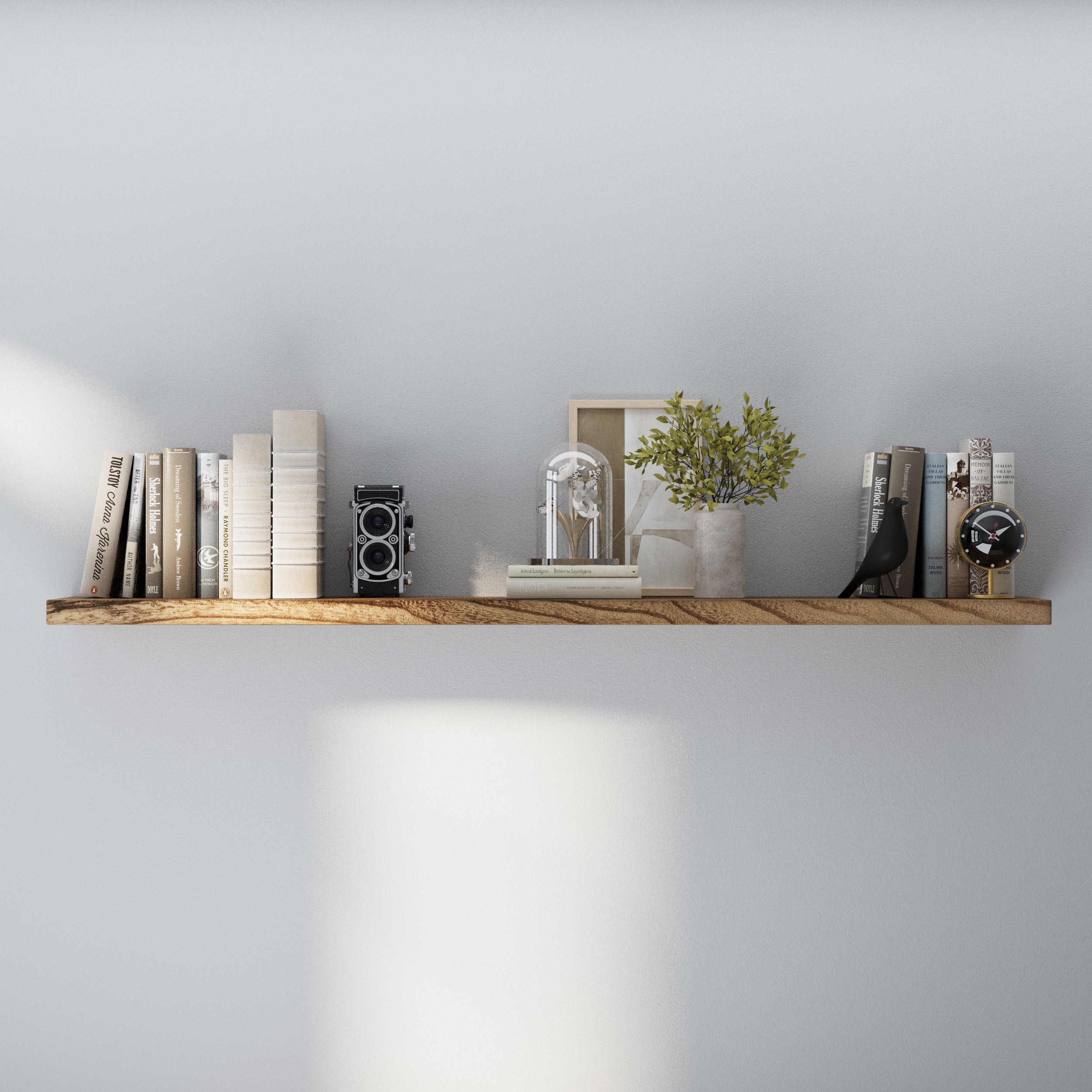 A 60 inch long floating shelf with hidden bracket mounted on a white wall, displaying vintage books, clock, flower art, and a bird design