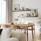 A pair of 60 inch long hanging shelves 2 inch thick with invisible brackets in dark walnut finish styled with neutral decor, enhancing a minimal dining space with clean lines and soft natural lighting.