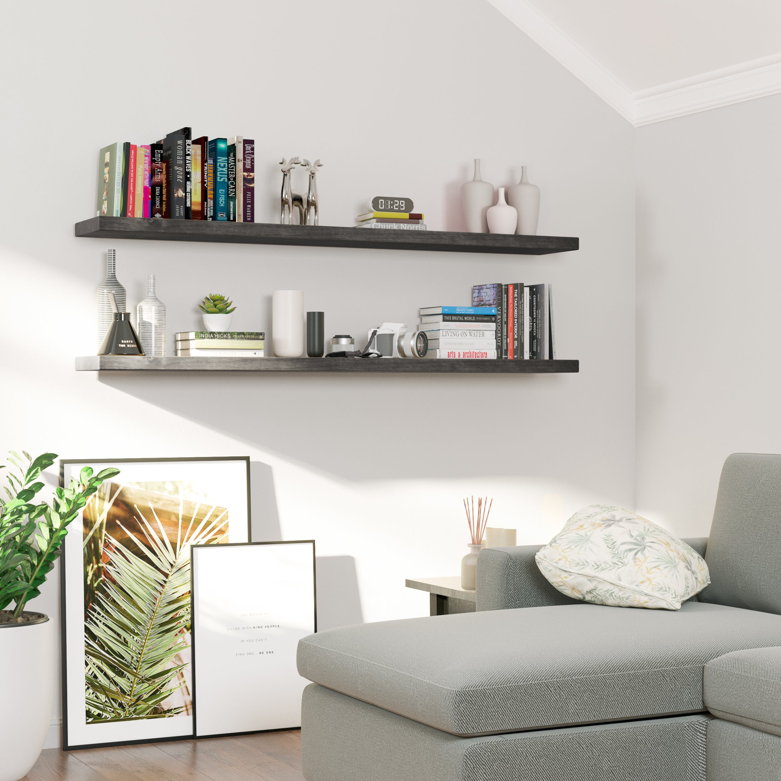 Two dark wood floating shelves with hidden brackets mounted in a cozy reading nook showcase books, cameras, small décor, and vases—balancing function and style above a soft gray sectional.