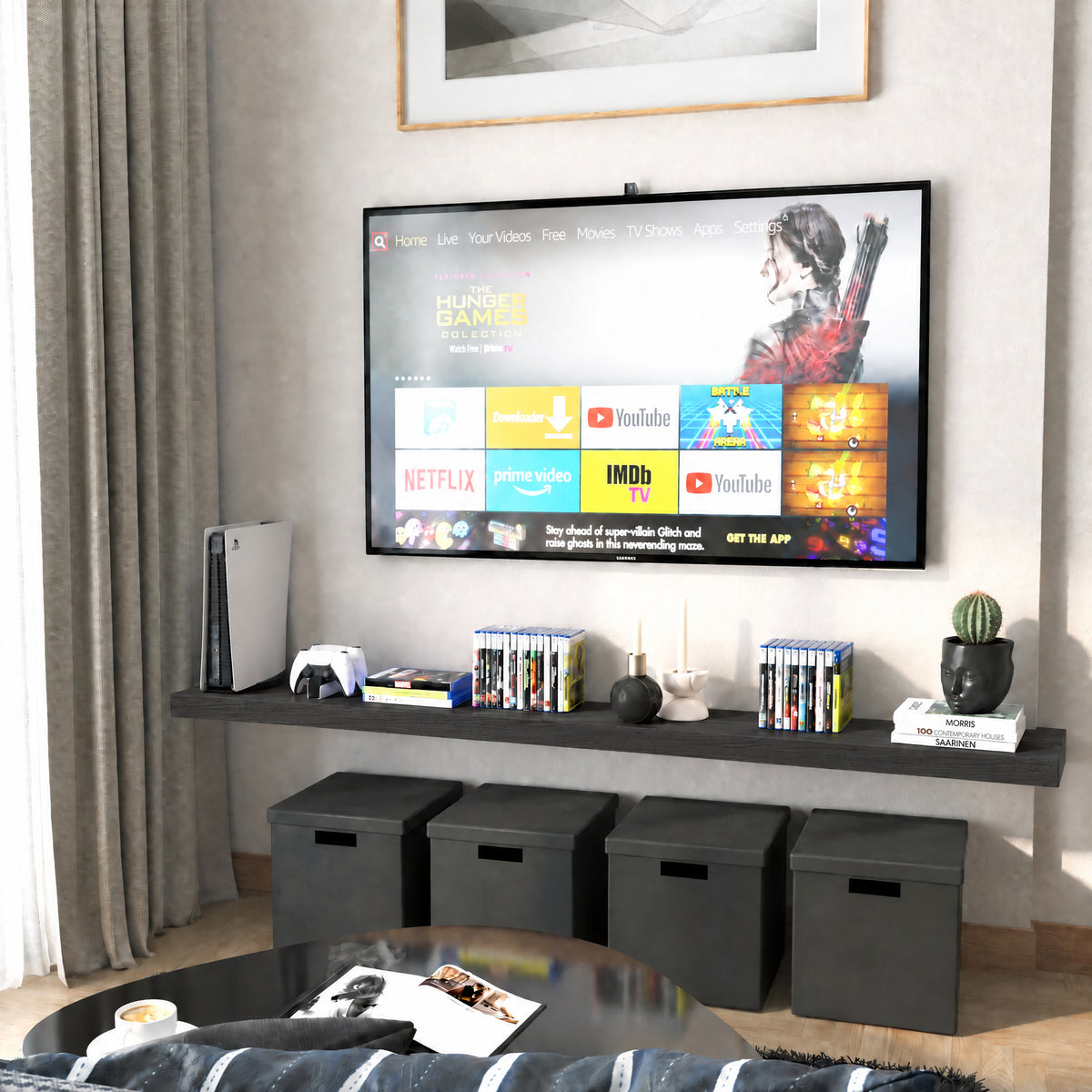 A 72 inch long floating wall shelf with invisible bracket in a rich ebony finish below a wall-mounted TV holds media items and decorative objects. Black cube storage and neutral tones complete the entertainment nook.