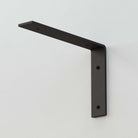 Sturdy black L-shaped metal shelf bracket for reliable wall-mounted shelving solutions.