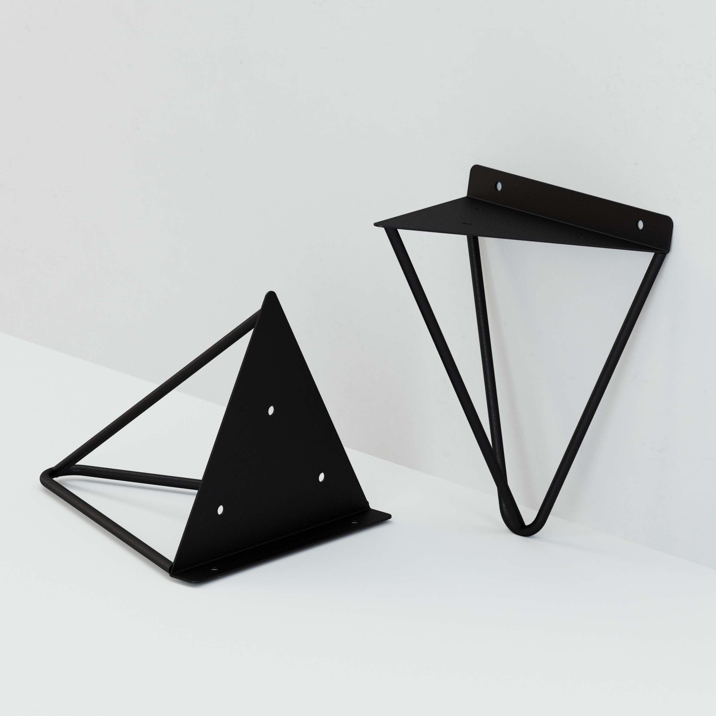 Two black triangular shelf brackets, one mounted and one on a flat surface.