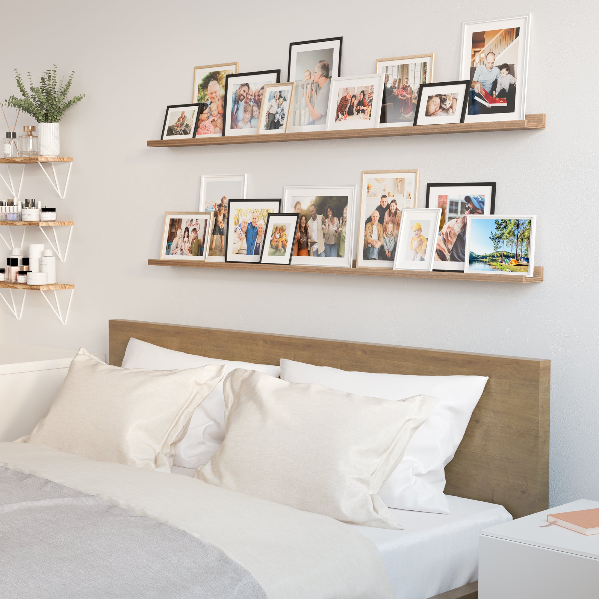 Bedroom with a bed and white linens, with wall shelves above displaying a variety of framed family photos.