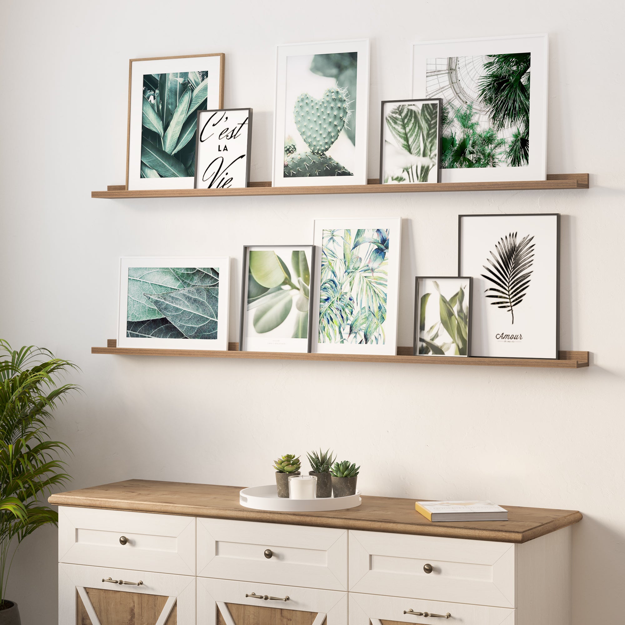 A warm interior with two wooden shelves displaying framed botanical prints above a sideboard with plants.