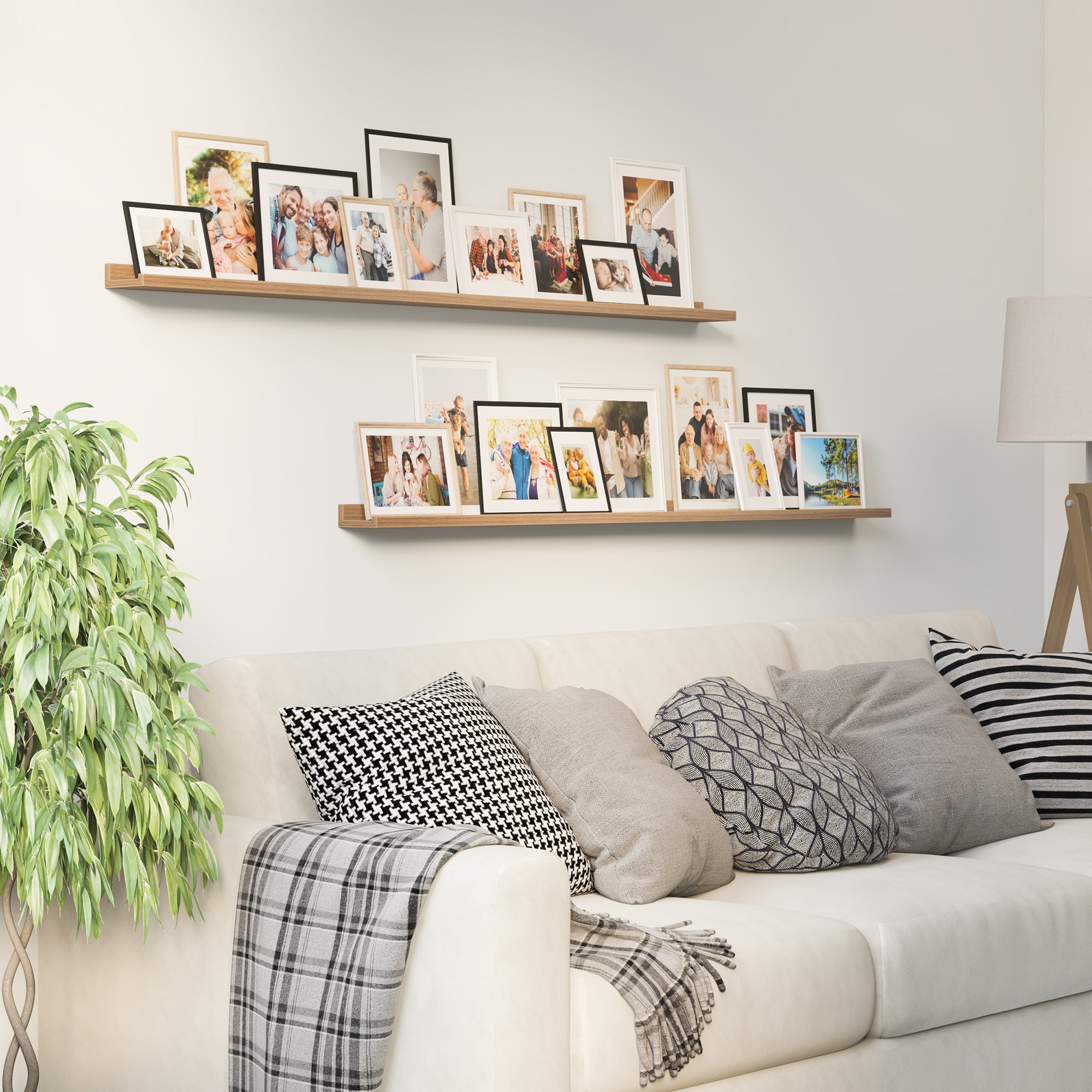 Living room with a comfortable couch and wall bookshelves above, adorned with a variety of framed family and personal photos.
