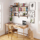 A stylish home office setup with floating office shelves above a desk, decorated with books, plants, and framed art, creating a productive yet cozy environment.