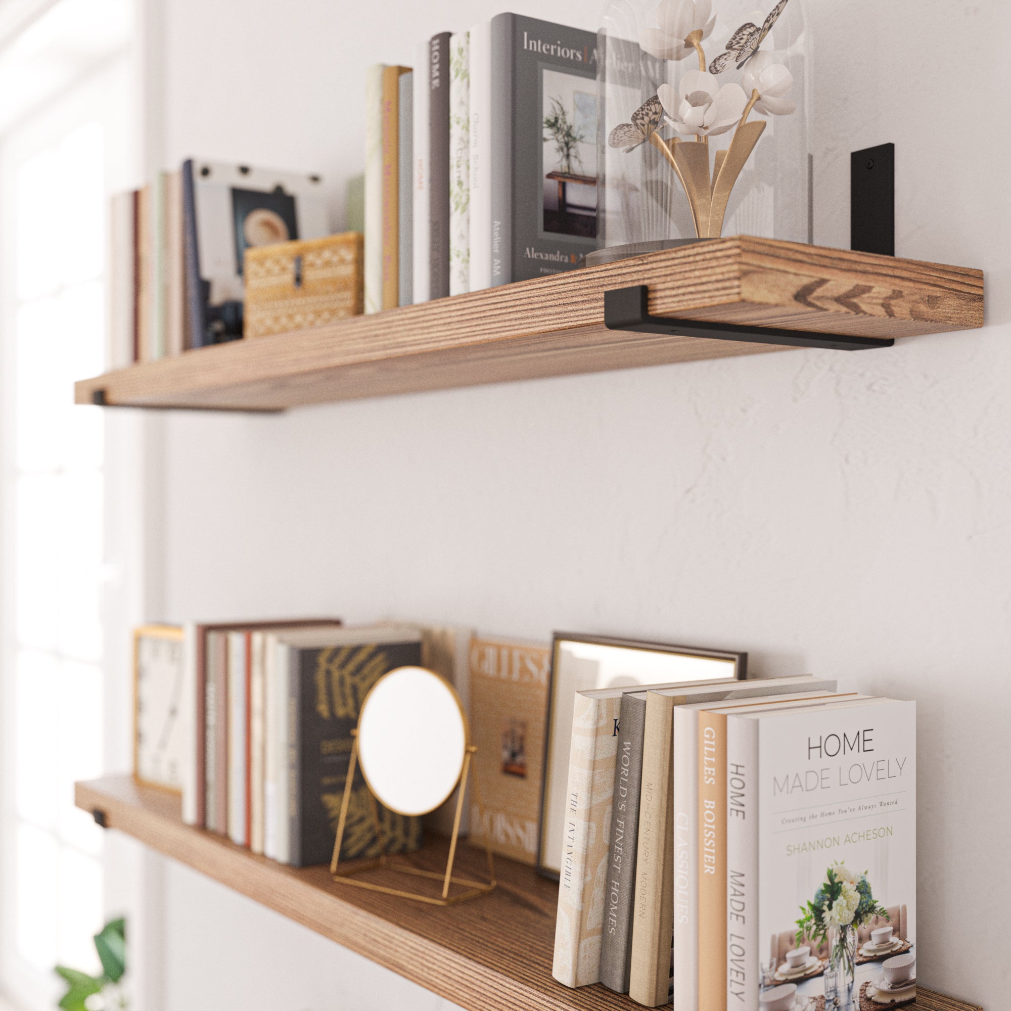 A close-up image of stylish books, frame, and clock on two storage shelves burnt.