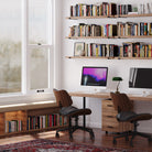 A home office featuring boho storage shelves filled with books, creating an organized and professional ambiance. A great use of vertical space for productivity and style.
