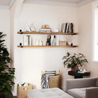 Cozy living room with two wood wall shelves for room decor displaying books and decorative items. Perfect for enhancing the aesthetic and functionality of your space.