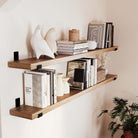 Two rustic floating book shelves for wall showcasing a mix of vintage decor and books. Ideal for adding a stylish and organized touch to your home office or living space.