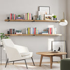 Two wooden living room shelves in a living room, styled with books and decorative accents, adding a modern touch.
