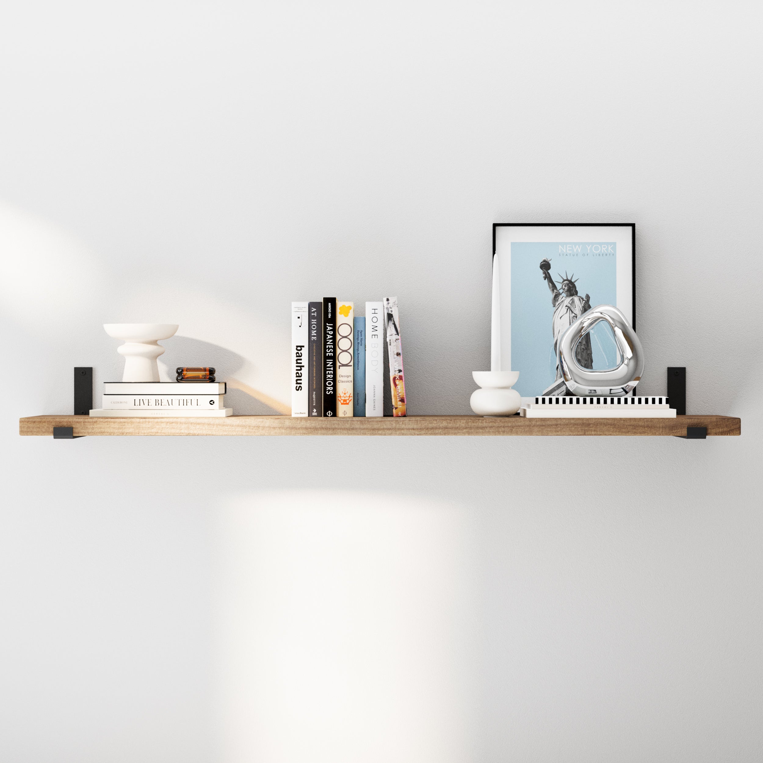 A minimalist solid wood shelf with modern decor accents in special walnut finish, featuring books, a candleholder, and a sculpture in a clean, uncluttered arrangement. Perfect for contemporary interiors.