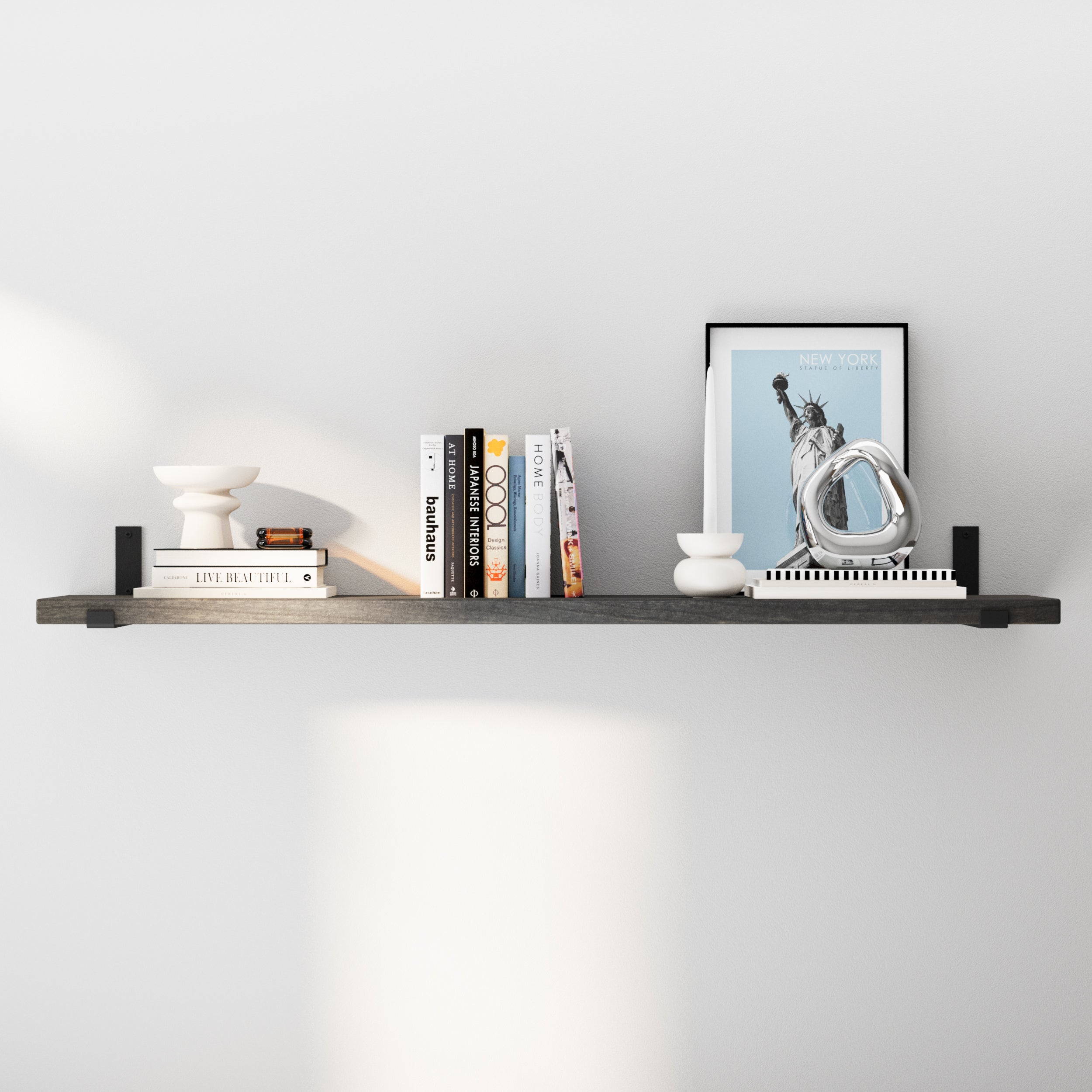 A variation of the floating shelf with a darker wood-ebony finish, showcasing similar decor items, highlighting its versatility in matching various color schemes and room designs.