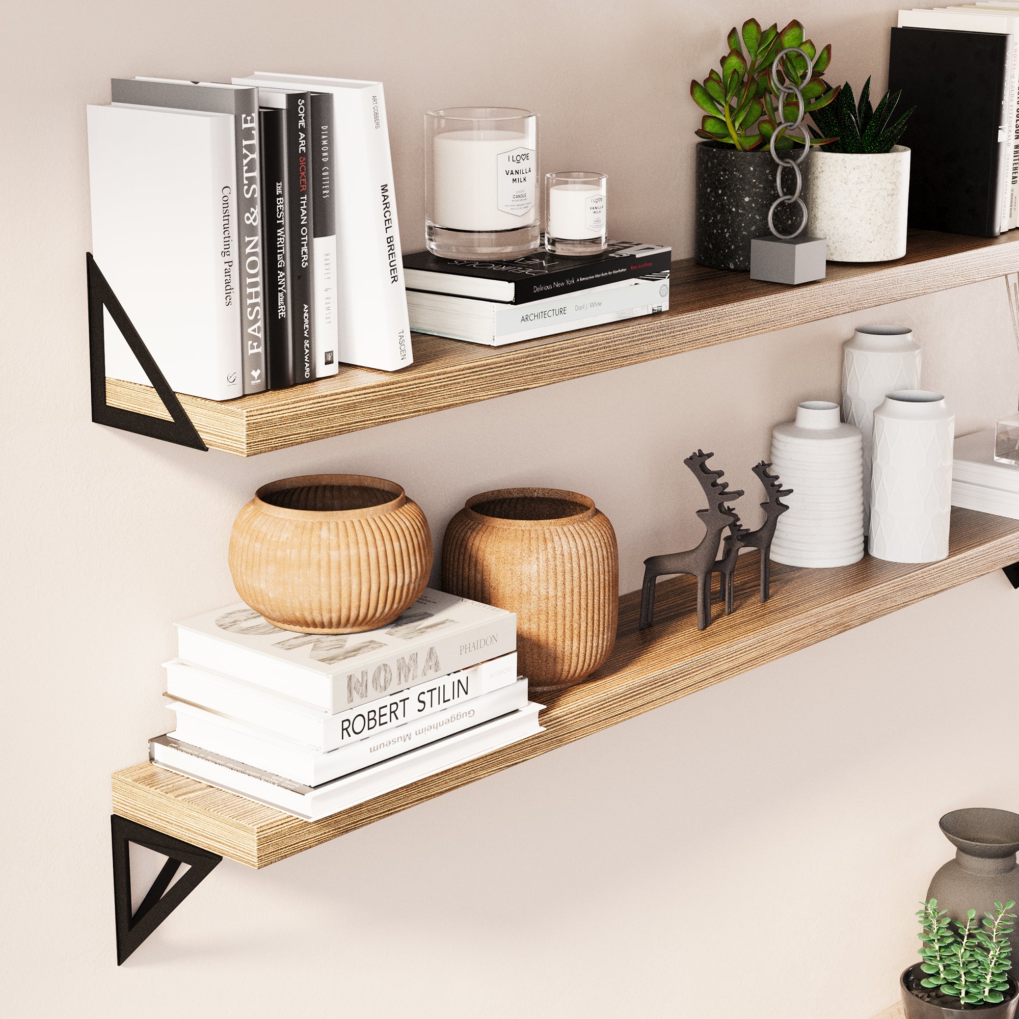 A close-up view of 2 floating display shelves show it adorned with books, vases, and small decor items. The focus is on the texture of the wood and the sturdy metal brackets, highlighting the quality of materials used.