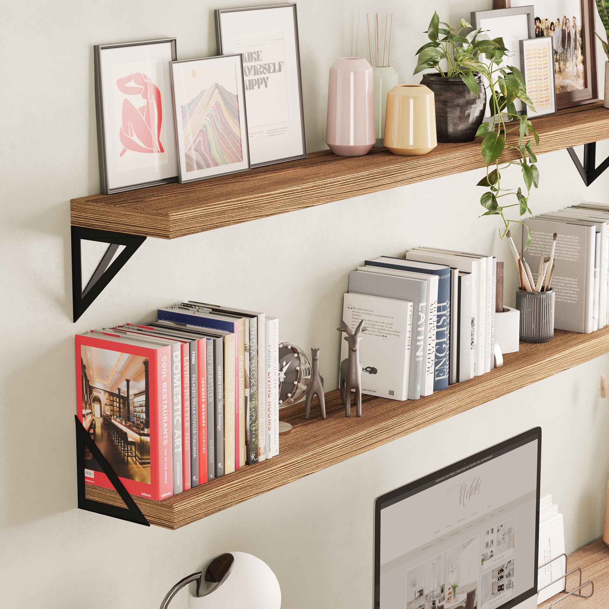 A close-up view of the Wallniture Minori floating book shelves 2 pieces installed in a home office setup. The shelf is decorated with books, framed artwork, and decorative items, demonstrating how it can be both a functional storage solution and a stylish element in a workspace.