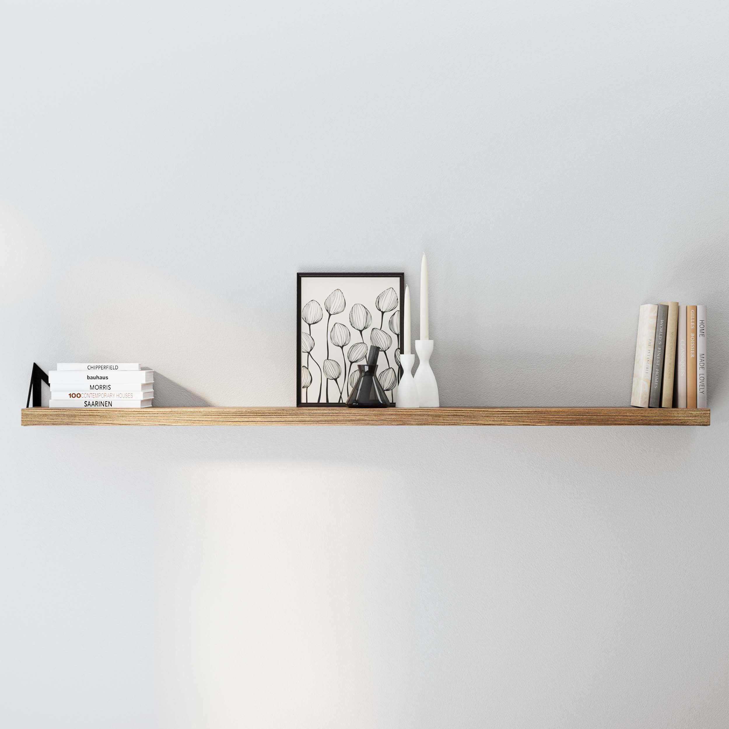  Wallniture Minori Shelf mounted on a wall with minimalistic decor. The shelf holds a few books, a framed picture, and decorative vases, emphasizing its sleek design and versatility in different room settings.