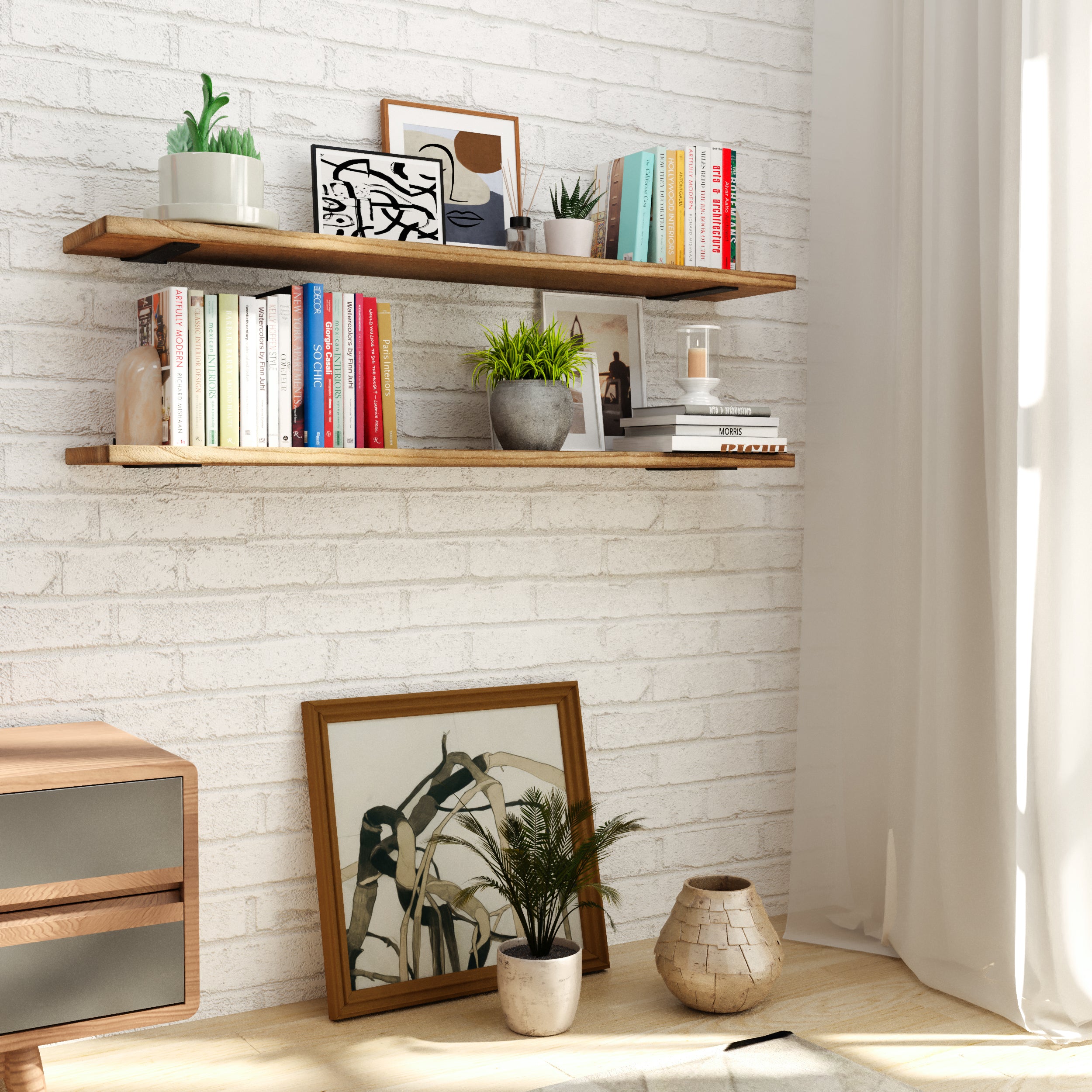 Two rustic floating shelves on a white brick wall, styled with books, vases, and green plants, ideal for adding a warm, rustic vibe to a modern living room.