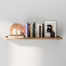 36 inch floating book shelf with a rich burnt finish, styled as a long wall shelf for books, framed art, and décor. This rustic floating shelf adds warm farmhouse charm to living room, bedroom, or office wall storage.
