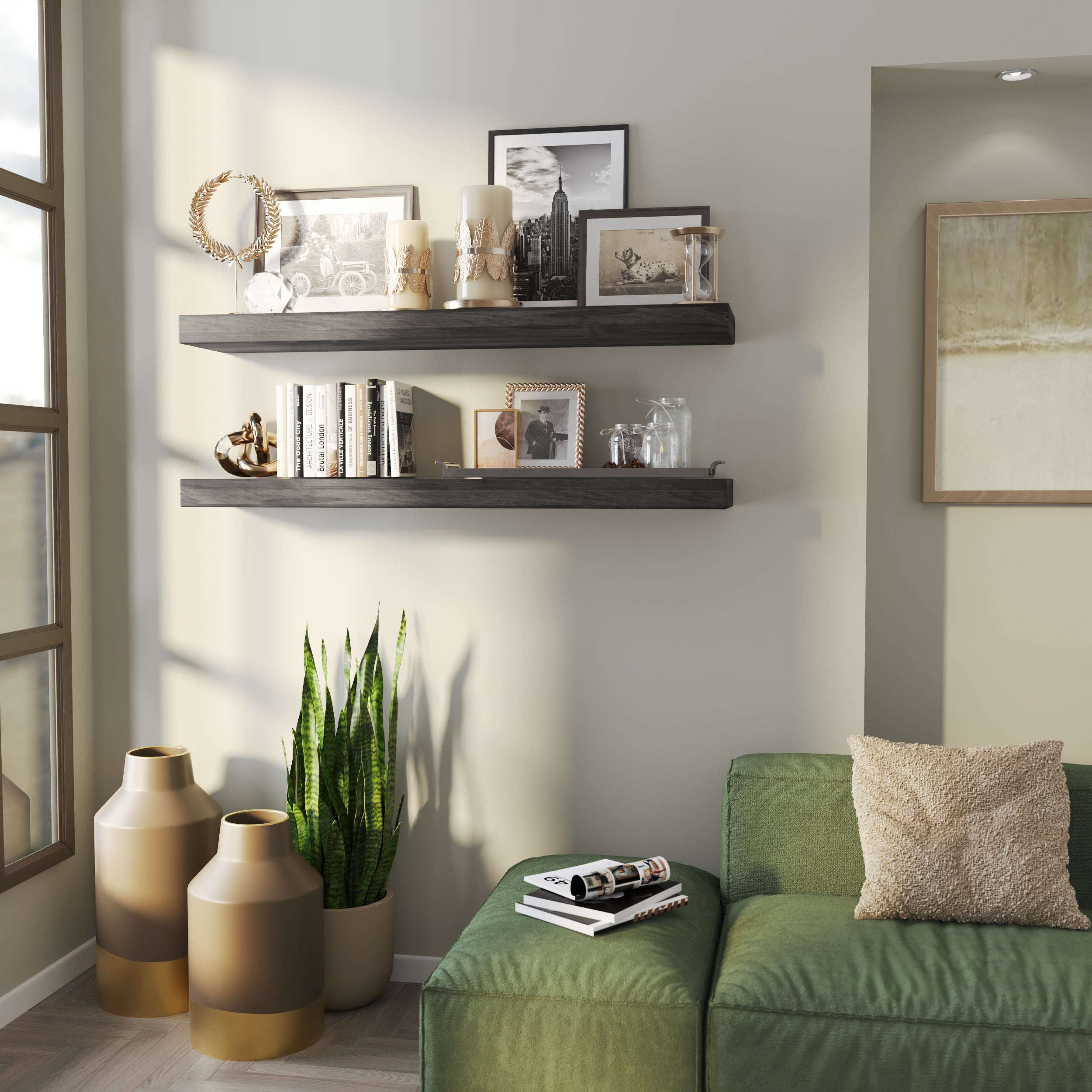 Two floating ebony-finish shelves styled with candles, framed photos, books, and glass decor. Accents a cozy corner with a green couch and decorative floor vases.