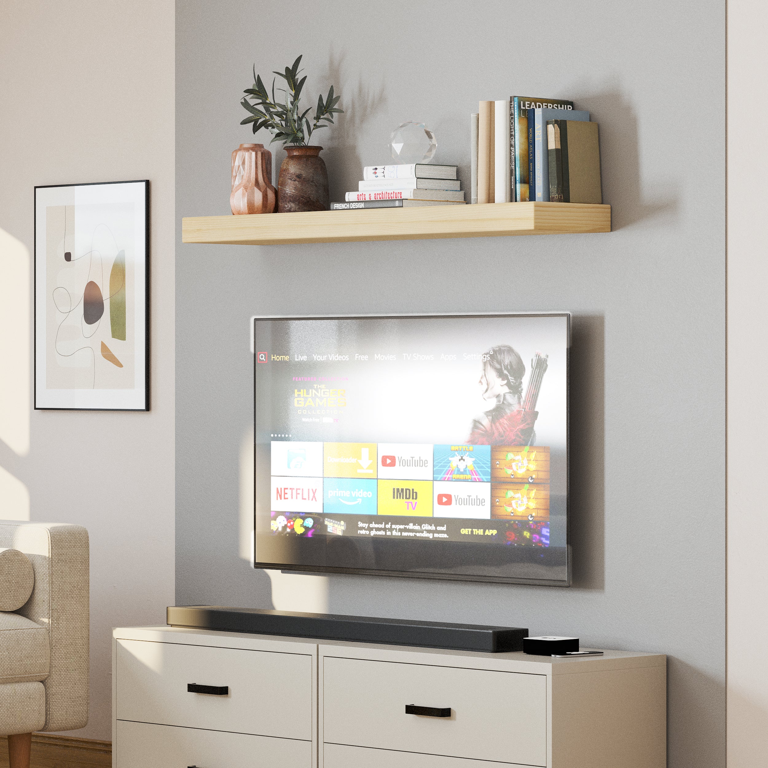 A single floating book shelf above a wall-mounted TV, decorated with modern vases and books, enhances the entertainment area with a simple yet stylish touch.