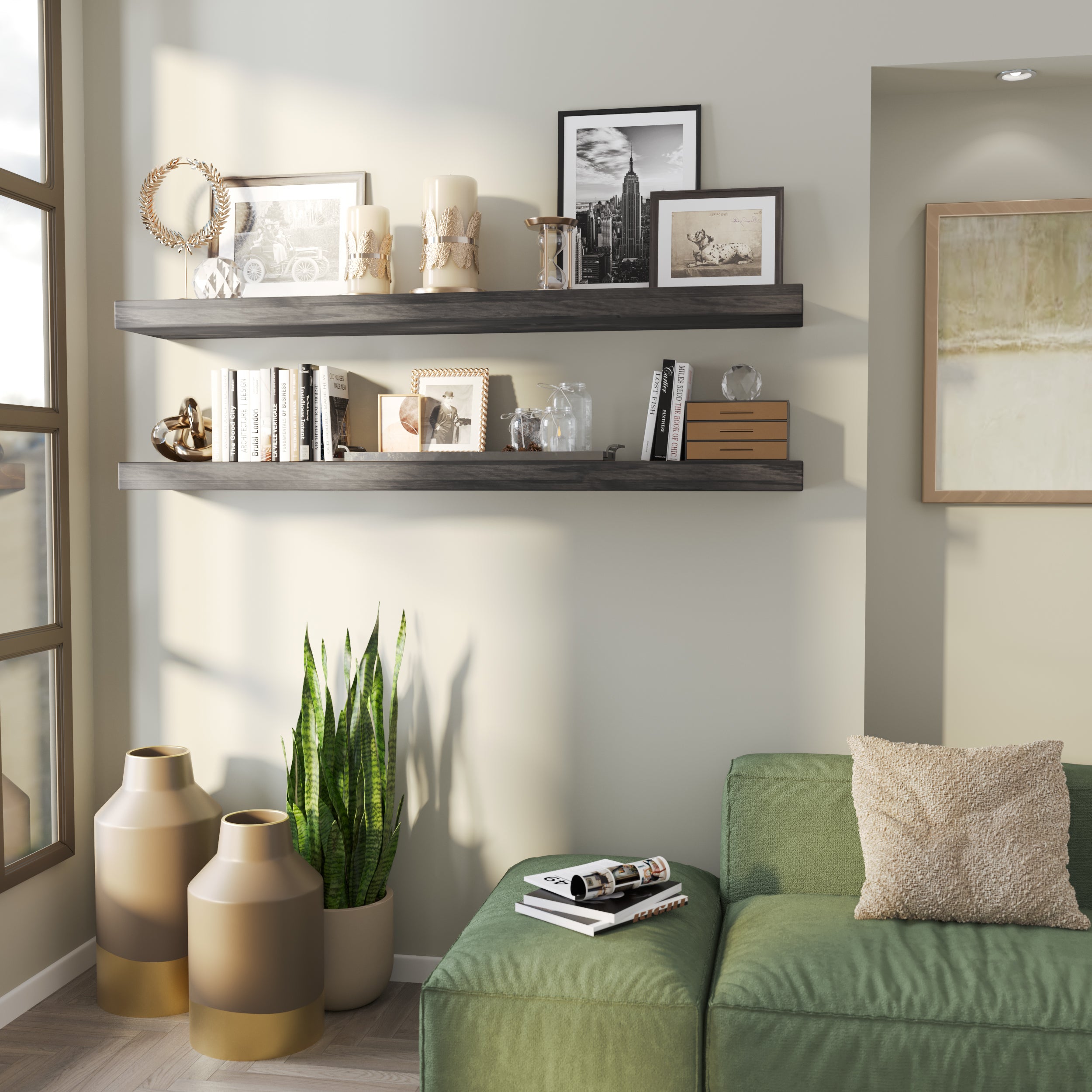 Two floating ebony-finish shelves styled with candles, framed photos, books, and glass decor. Accents a cozy corner with a green couch and decorative floor vases.