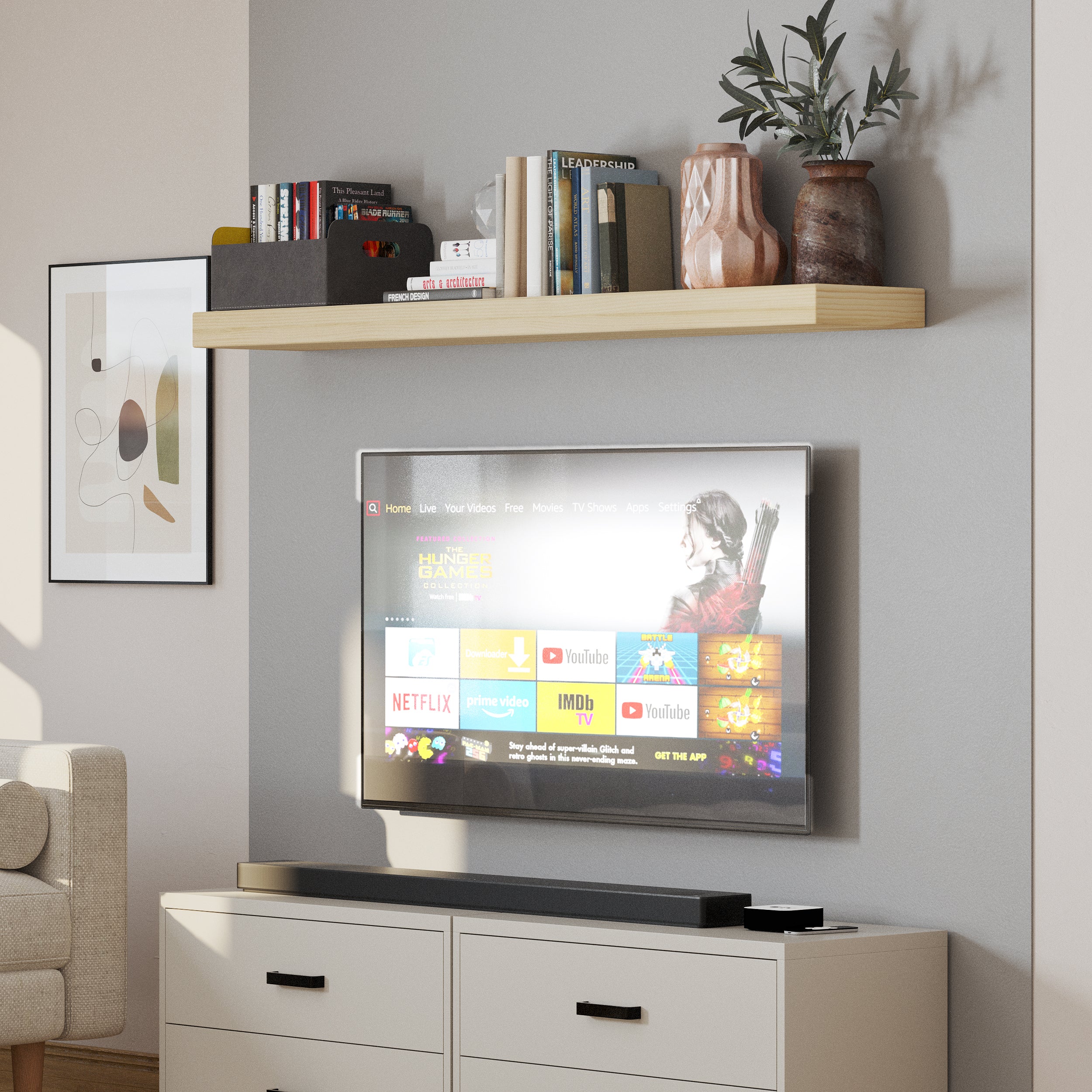 A single floating book shelf above a wall-mounted TV, decorated with modern vases and books, enhances the entertainment area with a simple yet stylish touch.