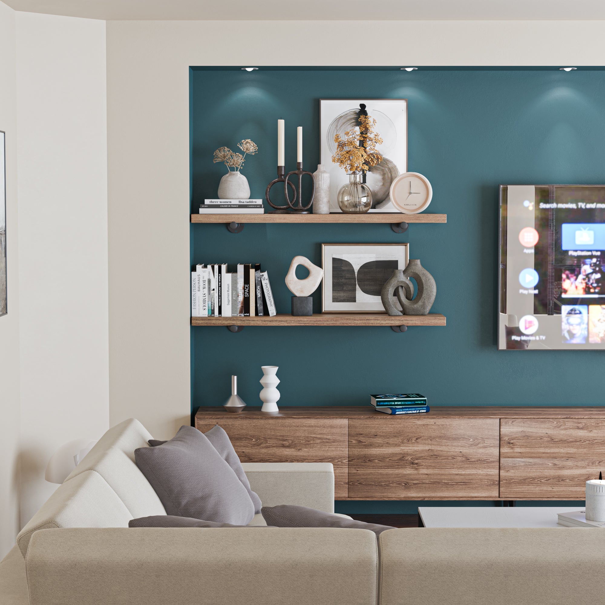 Living room bookshelves in a living room setting, decorated with books, vases, candles, and abstract sculptures. The shelves complement the room's modern decor with a cozy, organized appearance.