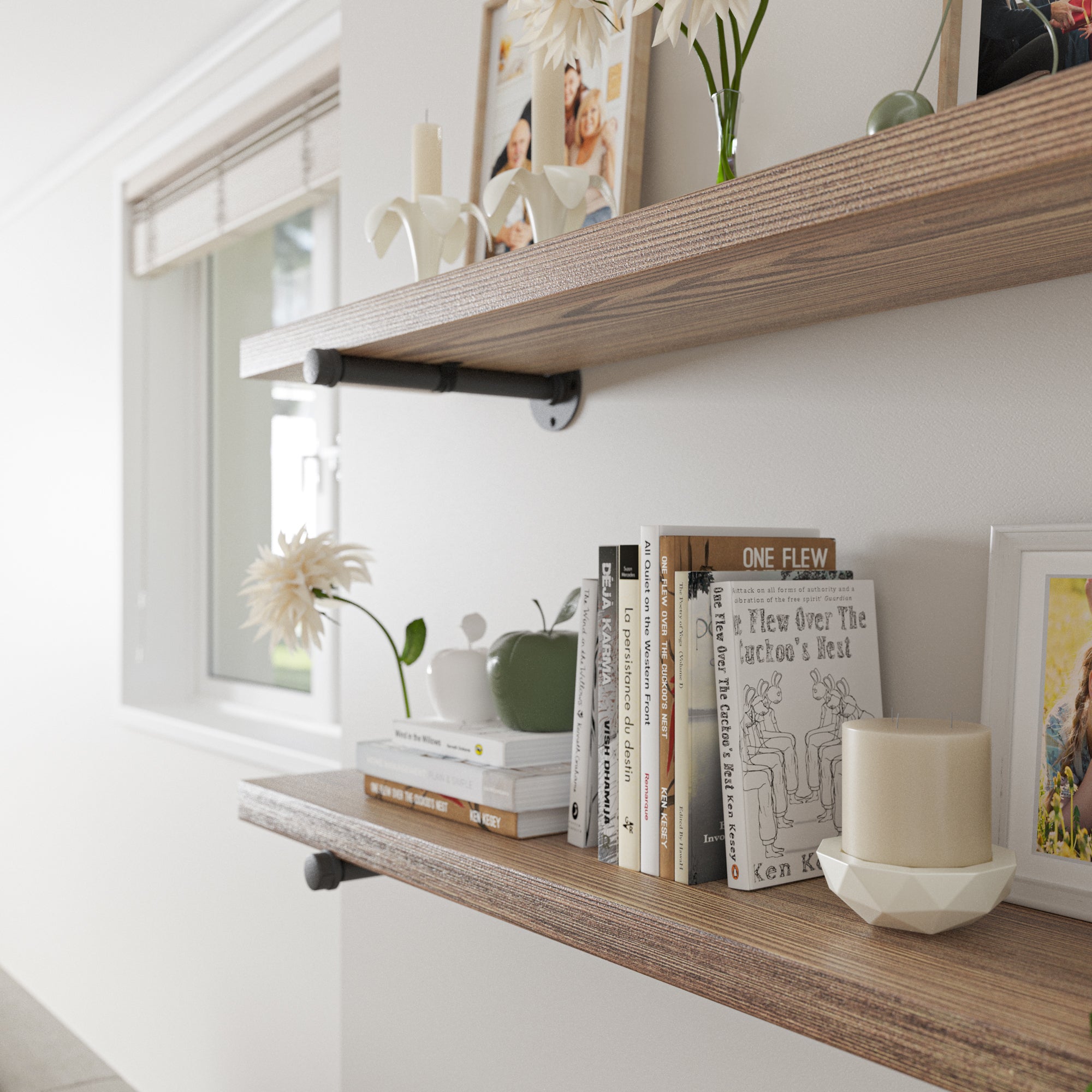  A close-up view of 2 rustic storage shelves, focusing on the items placed on them, including books, a candle, photo frames, and decorative pieces like flowers in vases, giving a detailed look at the shelf's styling and texture.