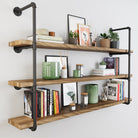 Room with PIPE 60'' Floating Pipe Shelves displaying books and decor; striking contrast of iron and wood.