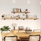 Three long shelves mounted in a dining space, showcasing books, candles, and elegant decor.