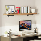 A study desk setup with a floating shelf above it, holding books, a clock, and decorative items. The shelf enhances the workspace with its functional and stylish design.