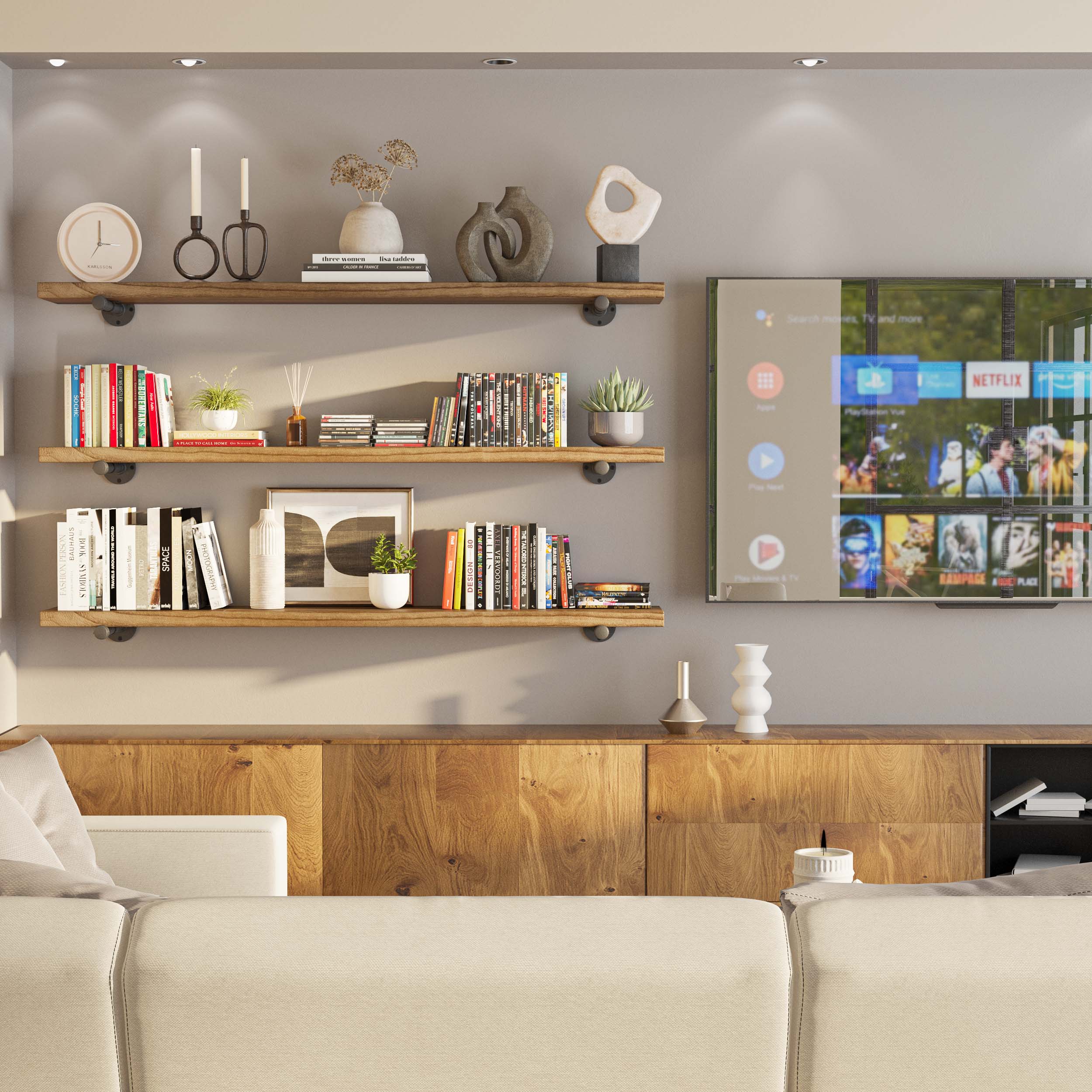 Three long floating shelves mounted in a TV room, styled with books and decor, complementing the entertainment setup.